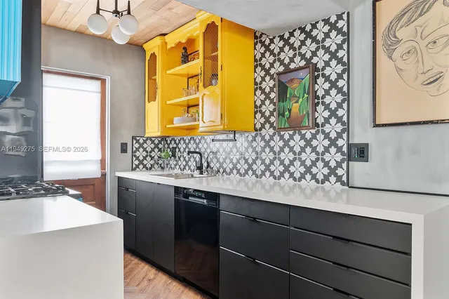 a hallway with a stove a faucet and a dining table