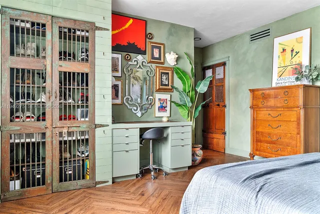 a bedroom with a bed and a potted plant
