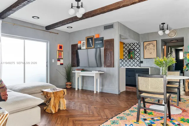 a living room with furniture a window and a chandelier