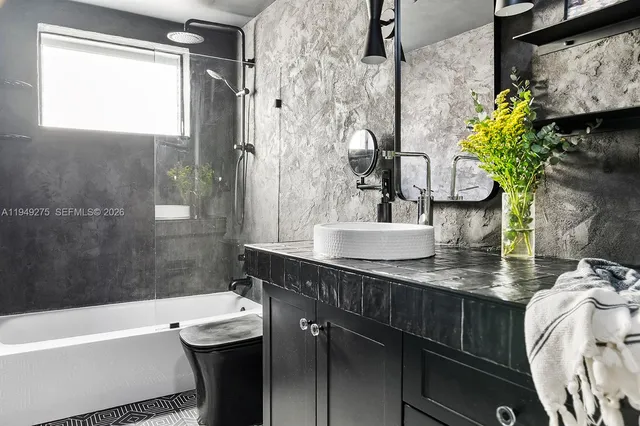 a bathroom with a sink toilet and shower