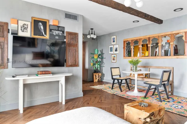a living room with furniture a table and chairs