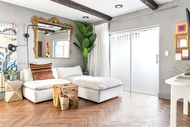 a bedroom with bed and wooden floor