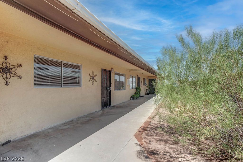 421 North Decatur Boulevard, Unit 2 Las Vegas, NV 89107 - Photo 2 of 21 A well-maintained stucco facade with multiple windows and entryways offers a welcoming curb appeal.
