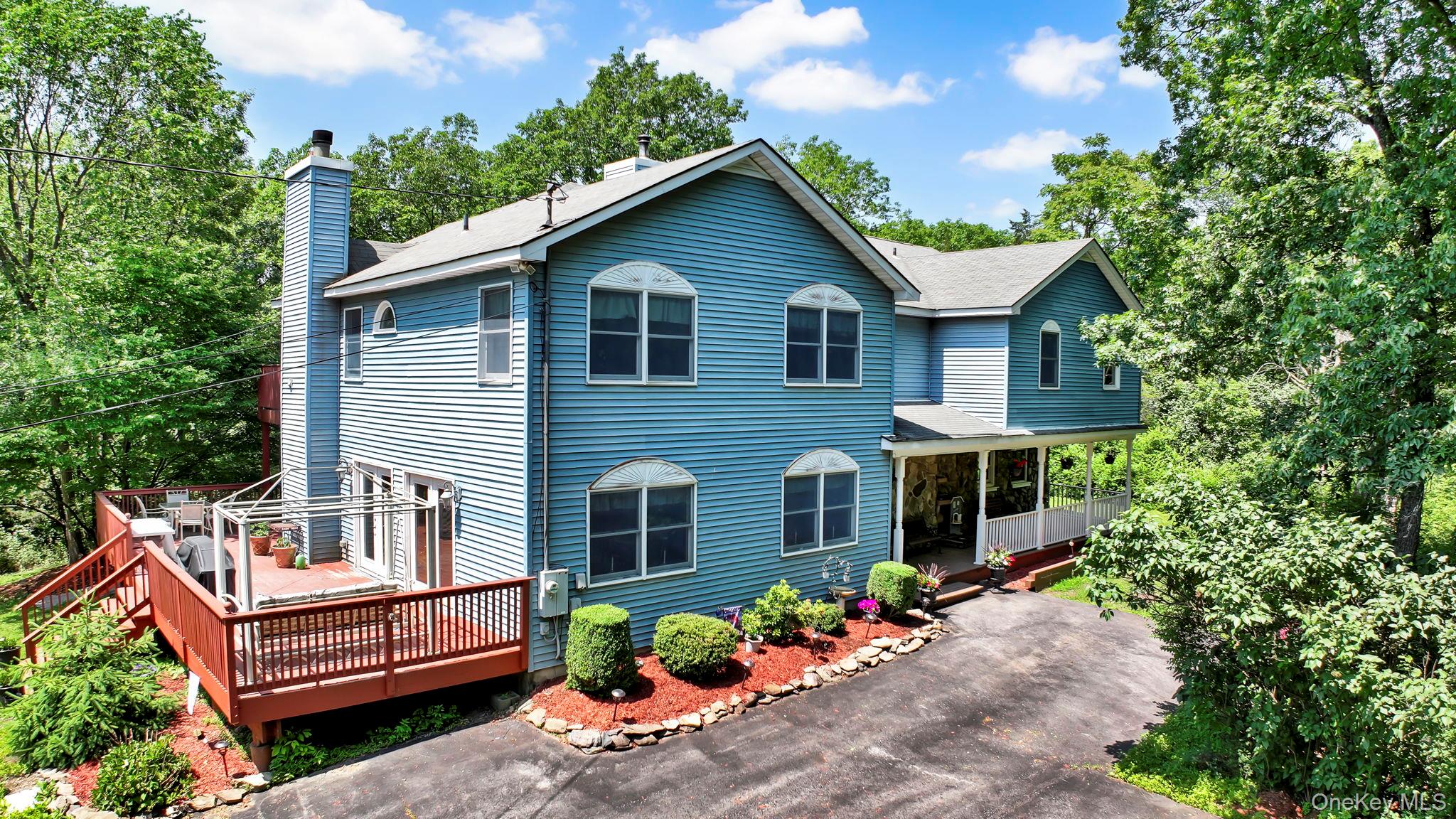 a view of a house with a yard and potted plants