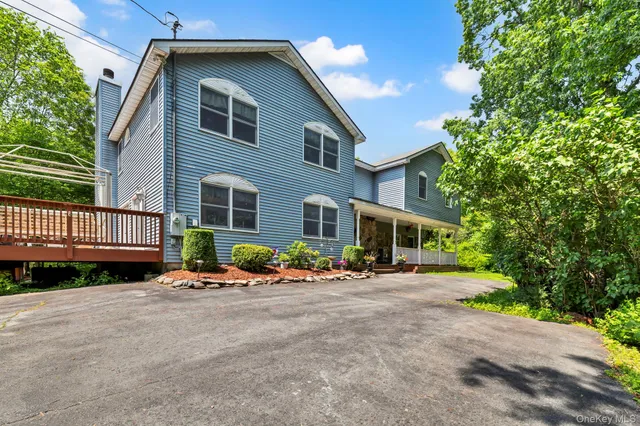 a front view of a house with a yard and table and chairs