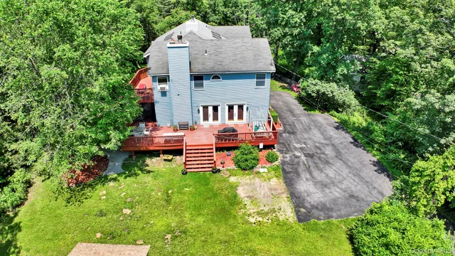 an aerial view of a house with a yard