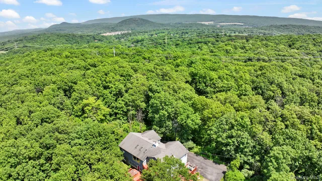 an aerial view of a house with a yard and garden