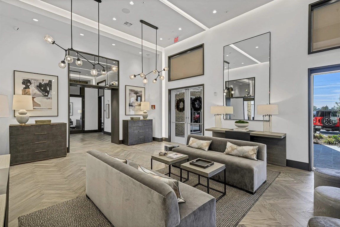 a living room with furniture and a kitchen