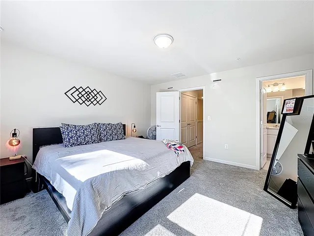 an aerial view of a city with lots of residential buildings and mountain view in back