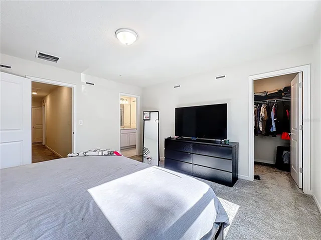 an aerial view of a house with swimming pool and large trees