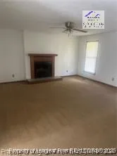 a view of an empty room with a fireplace