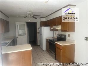1235 Wilderness Drive Spring Lake, NC 28390 - Photo 4 of 11 a kitchen with stainless steel appliances granite countertop a stove a refrigerator and a sink