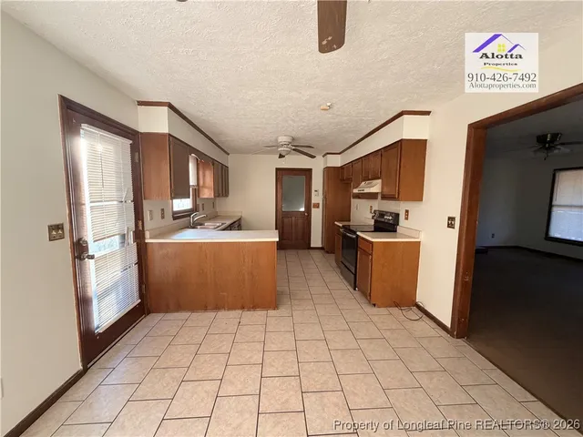a kitchen with stainless steel appliances a refrigerator sink and cabinets