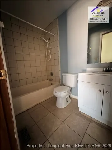 a bathroom with a toilet a sink and a shower