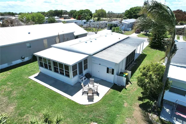 an aerial view of a house with a big yard