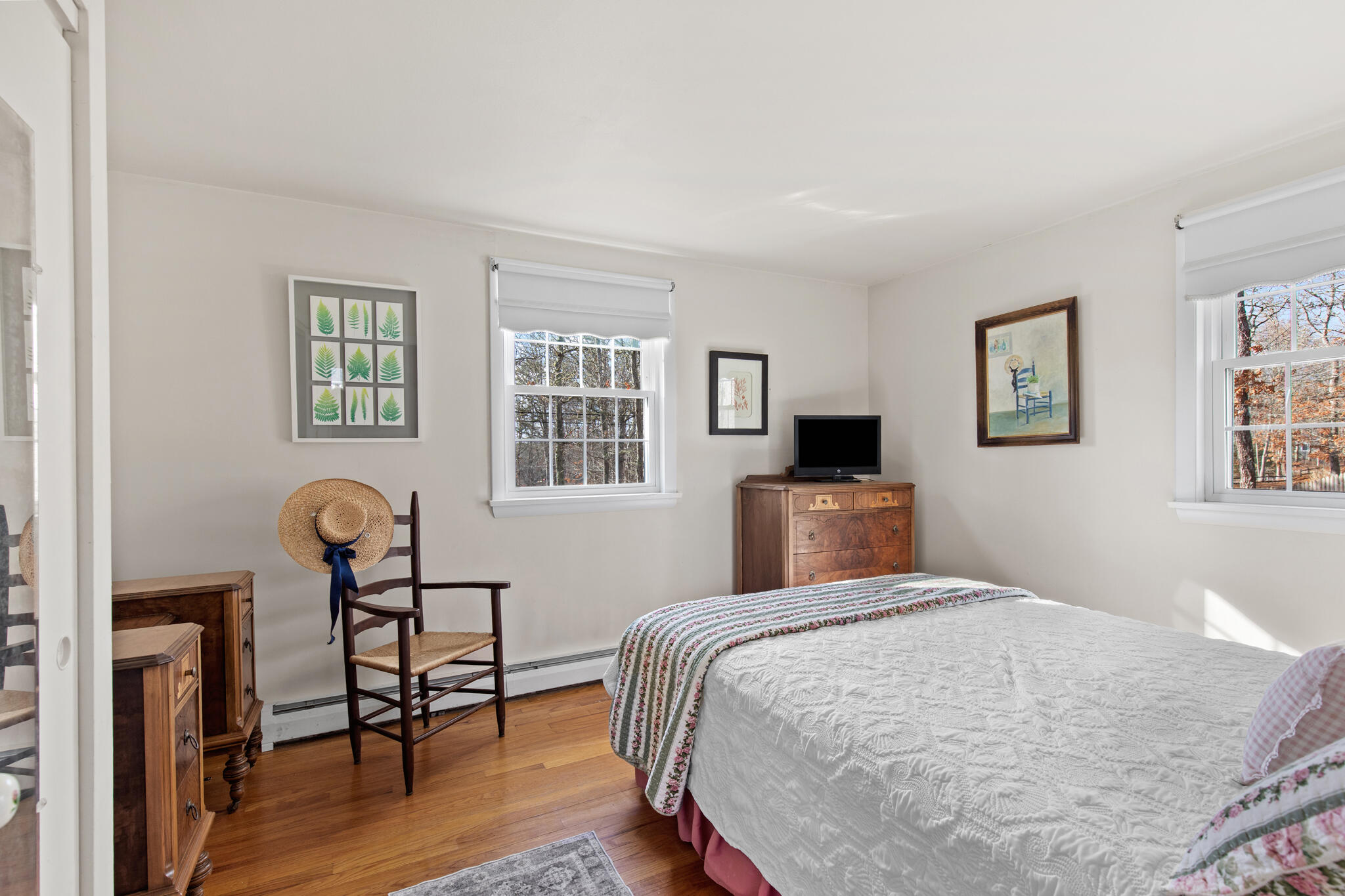 157 Jonathans Way Brewster, MA 02631 - Photo 21 of 38 a bedroom with a bed and a chandelier