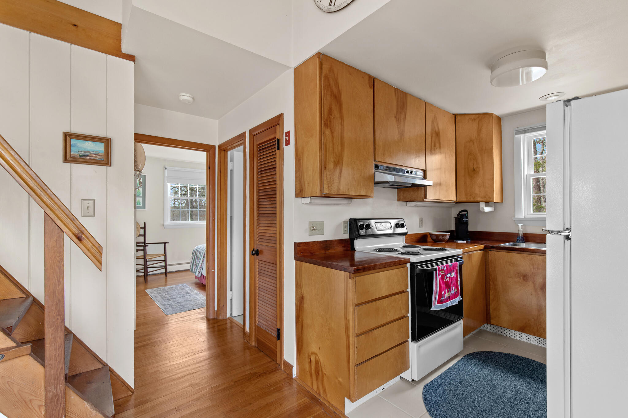 157 Jonathans Way Brewster, MA 02631 - Photo 24 of 38 a kitchen with stainless steel appliances granite countertop a stove top oven a refrigerator a sink and dishwasher with wooden floor
