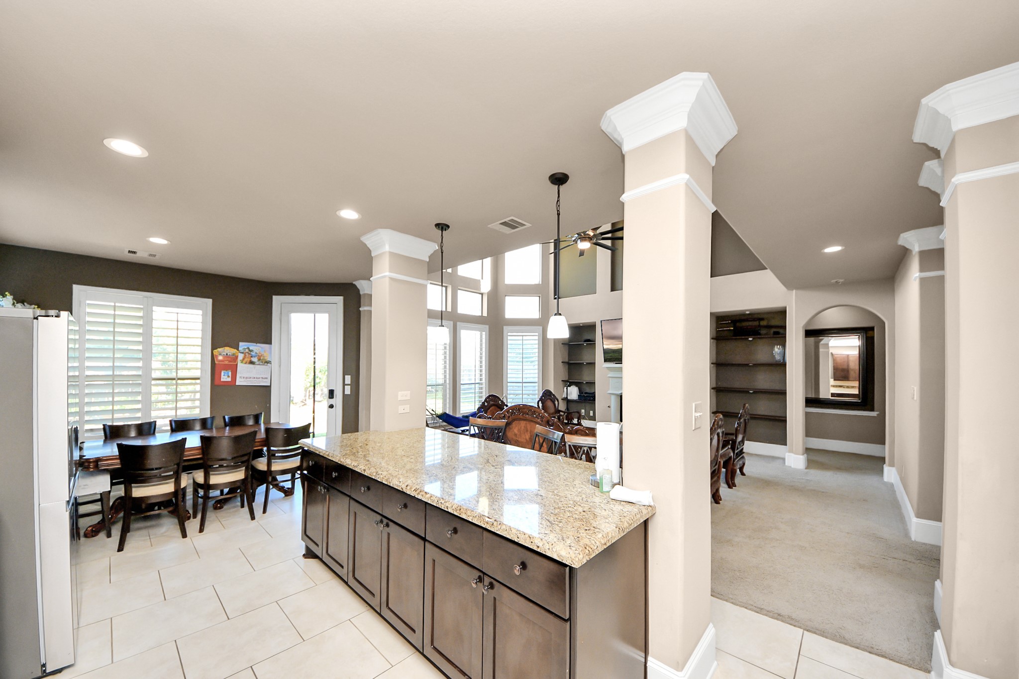 8447 Roland Canyon Drive Cypress, TX 77433 - Photo 17 of 41 a large kitchen with kitchen island a sink table and chairs