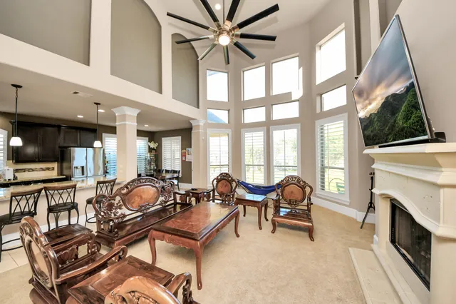a living room with furniture a fireplace and a flat screen tv