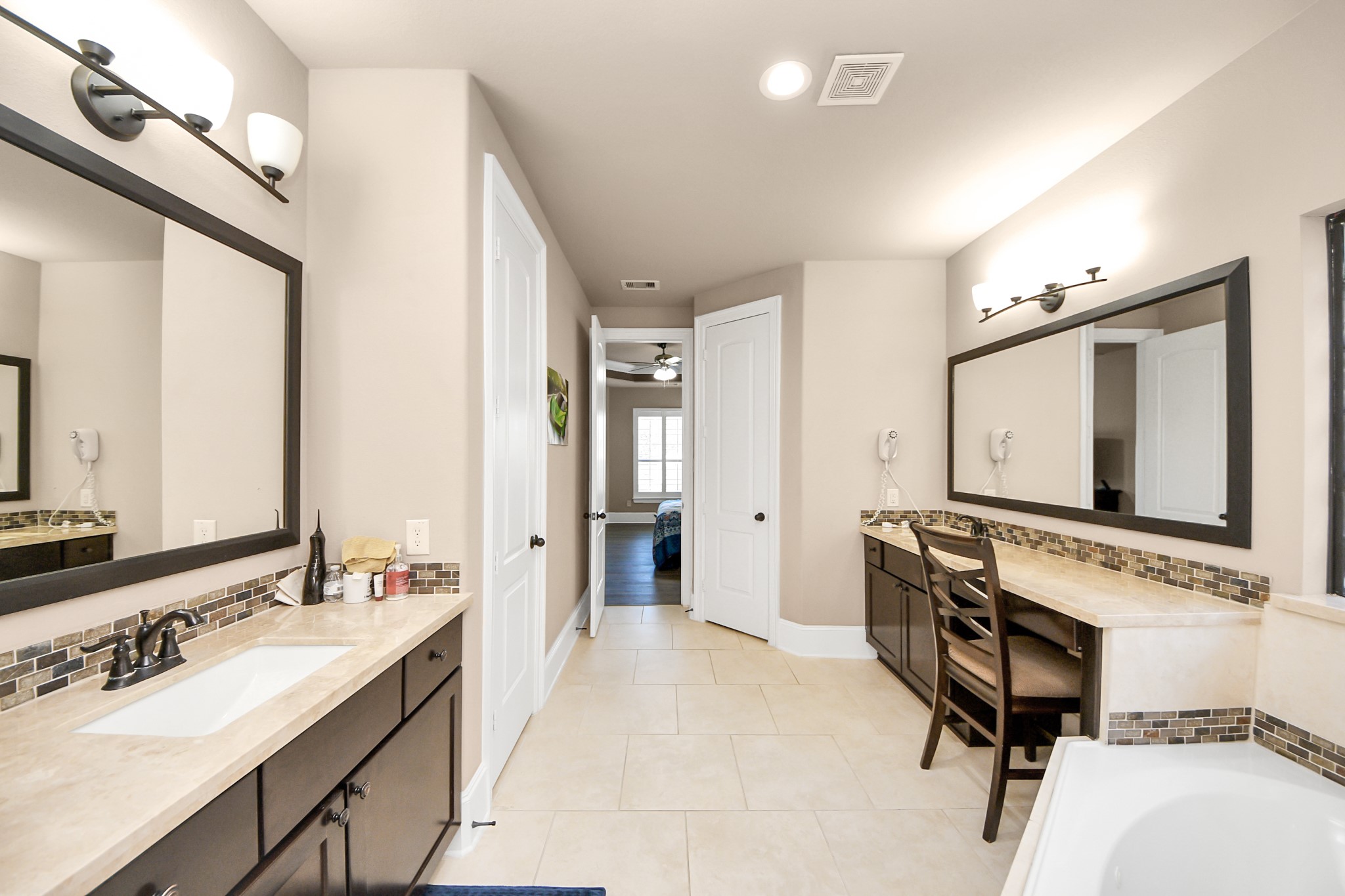 8447 Roland Canyon Drive Cypress, TX 77433 - Photo 27 of 41 a spacious bathroom with a granite countertop sink and a mirror