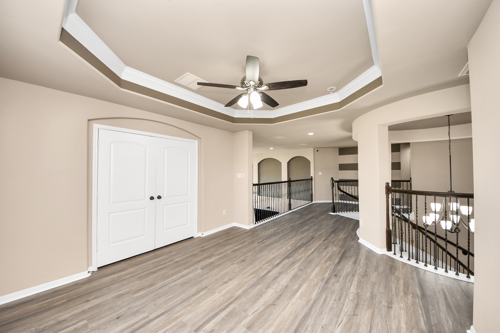 8447 Roland Canyon Drive Cypress, TX 77433 - Photo 34 of 41 a big room with wooden floor chandelier and windows