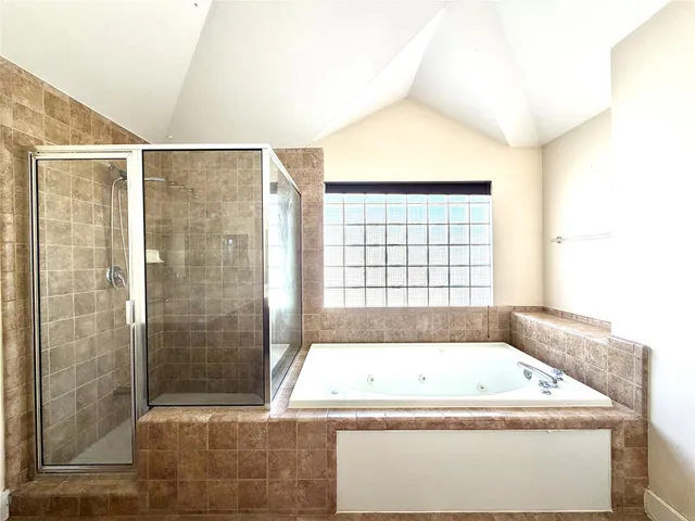 a view of bathroom with bathtub and shower