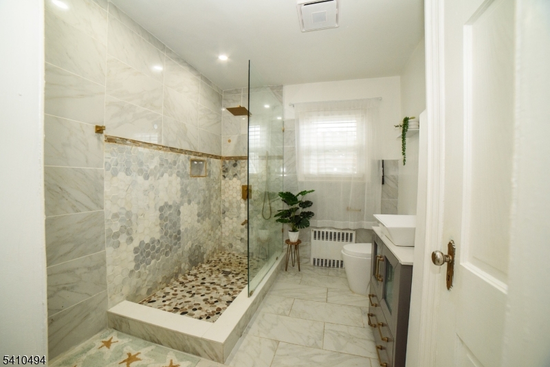 415 19th Avenue Paterson, NJ 07504 - Photo 16 of 35 a bathroom with a shower and a sink