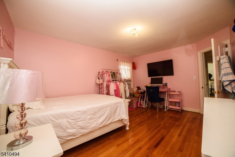 415 19th Avenue Paterson, NJ 07504 - Photo 20 of 35 a bedroom with a bed and a flat screen tv
