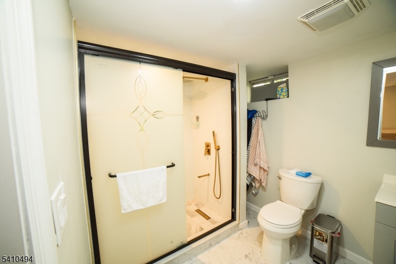 415 19th Avenue Paterson, NJ 07504 - Photo 26 of 35 a bathroom with a granite countertop sink toilet and shower