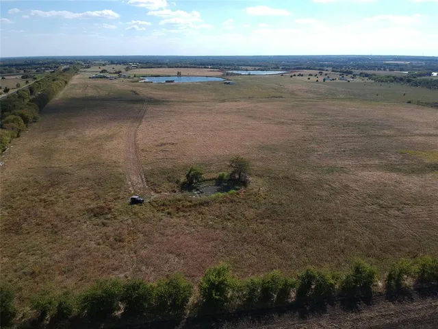a view of a field with an ocean beach