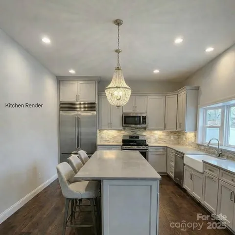 a kitchen with a center island appliances and cabinets