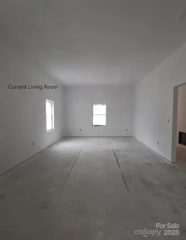 an empty room with a empty space and windows