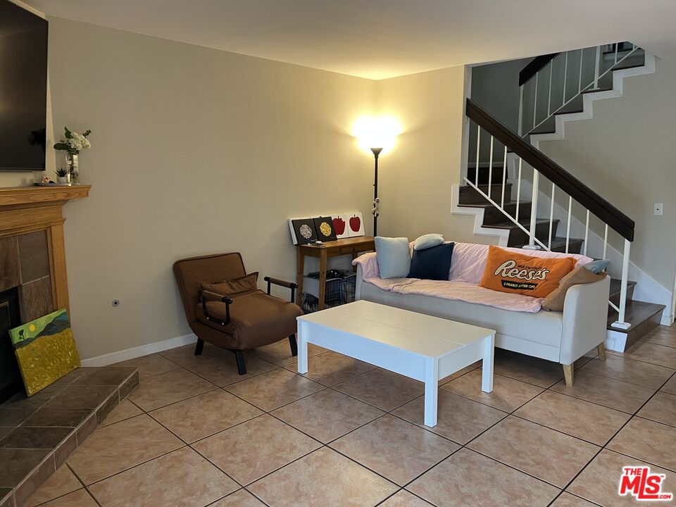 19528 Eagle Ridge Lane Porter Ranch, CA 91326 - Photo 7 of 20 a living room with furniture and a flat screen tv