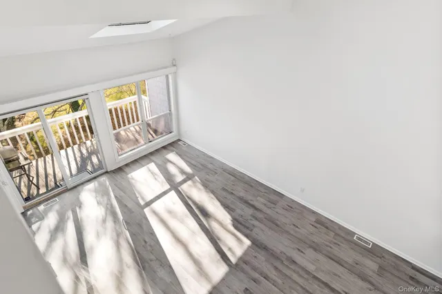 a view of an empty room and wooden floor