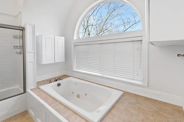 a white bath tub sitting next to a window