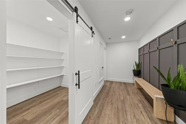 a view of a hallway with wooden floor and staircase