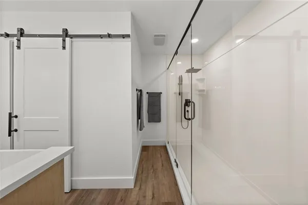 a bathroom with a shower and a sink