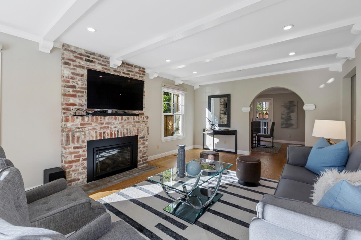 1001 Harvard Road San Mateo, CA 94402 - Photo 12 of 54 a living room with furniture fireplace and flat screen tv