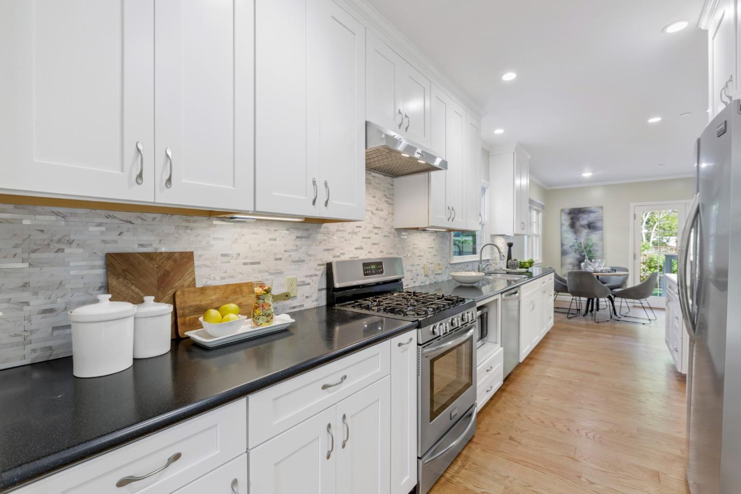 1001 Harvard Road San Mateo, CA 94402 - Photo 16 of 54 a kitchen with a sink a stove and cabinets