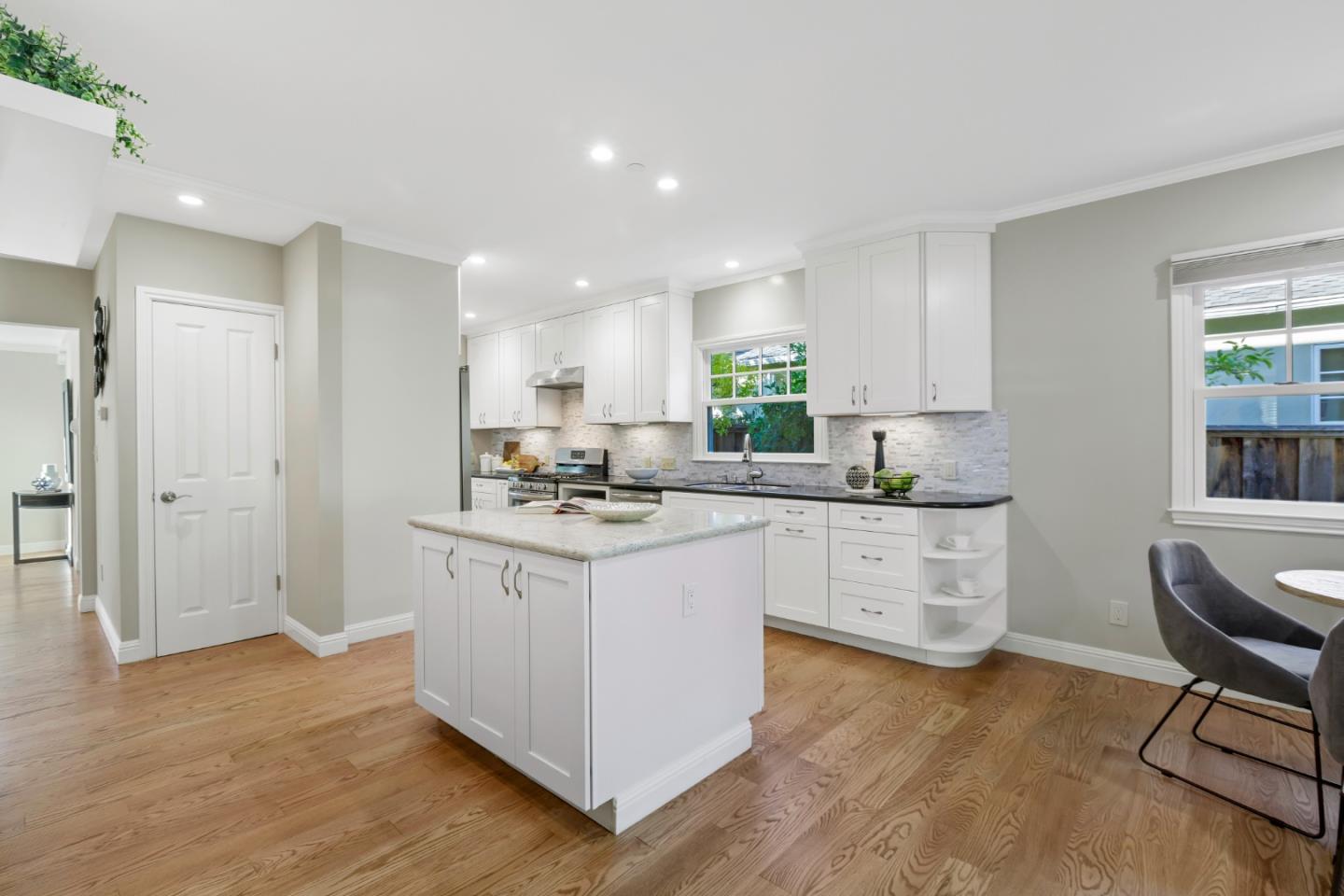 1001 Harvard Road San Mateo, CA 94402 - Photo 19 of 54 a kitchen with granite countertop white cabinets a sink a window and stainless steel appliances