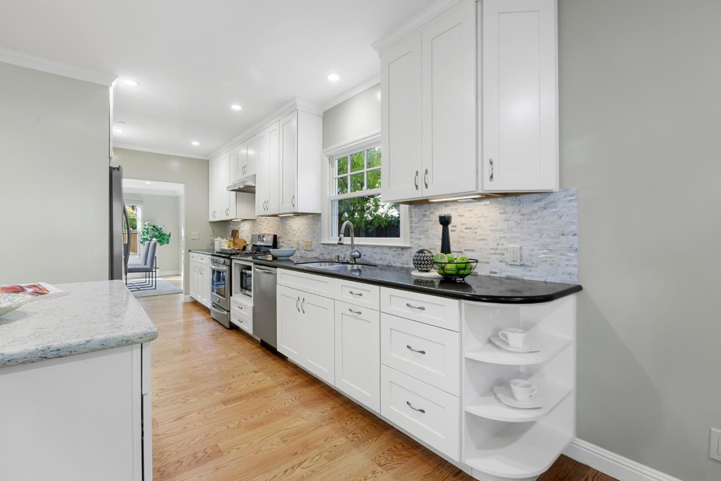 1001 Harvard Road San Mateo, CA 94402 - Photo 20 of 54 a kitchen with granite countertop a sink a stove cabinets and a dining table