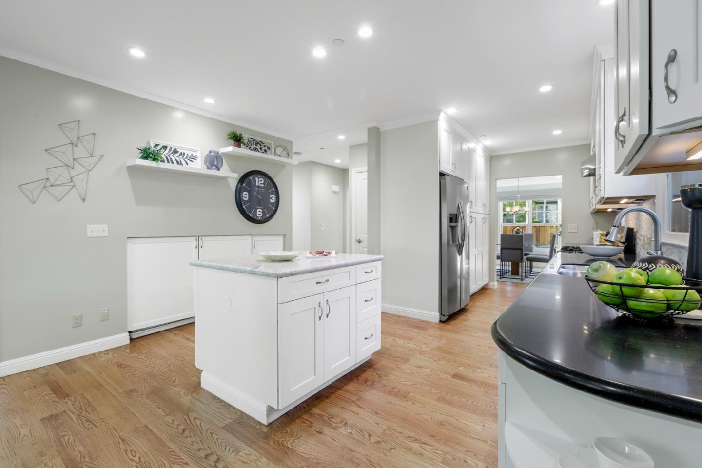 1001 Harvard Road San Mateo, CA 94402 - Photo 21 of 54 a kitchen with kitchen island granite countertop a sink a stove and a wooden floors