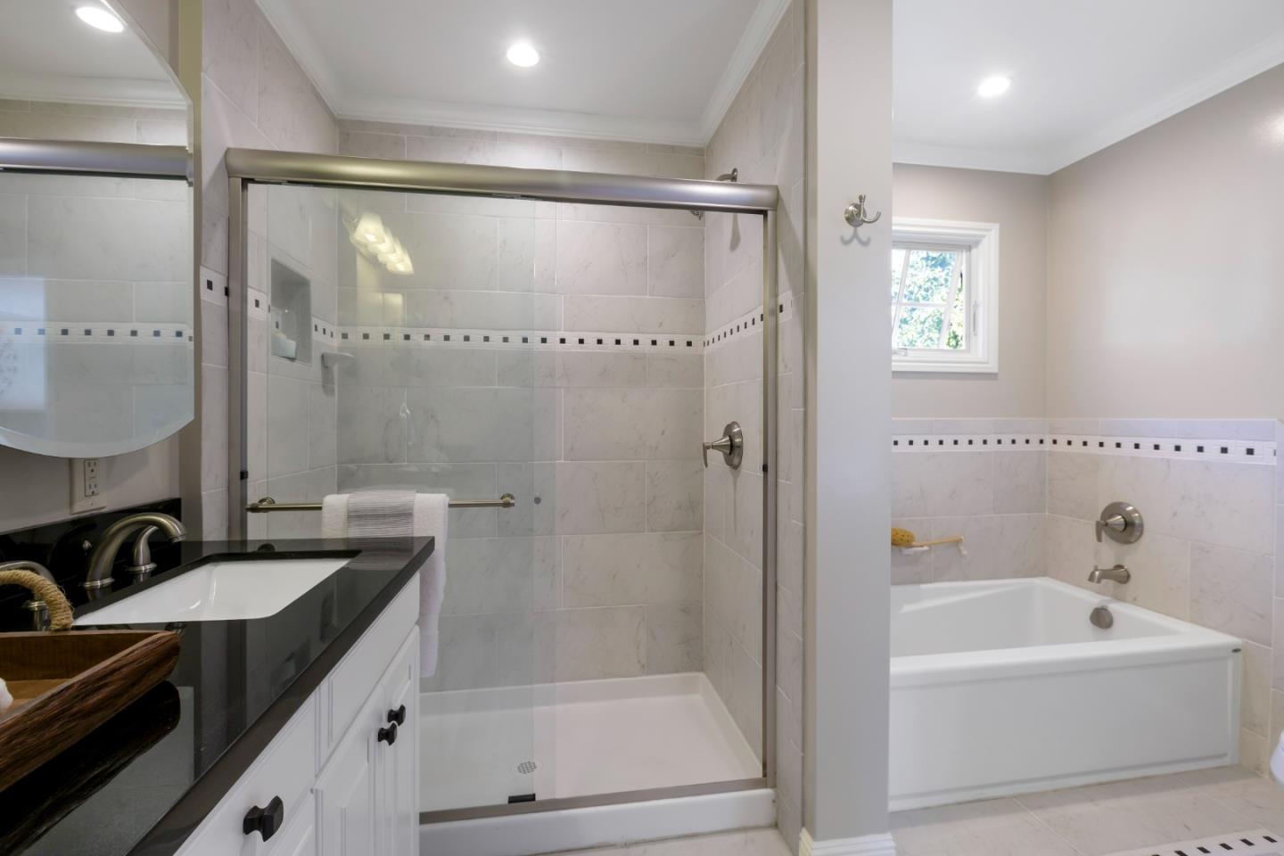 1001 Harvard Road San Mateo, CA 94402 - Photo 28 of 54 a bathroom with a granite countertop sink mirror bathtub and shower