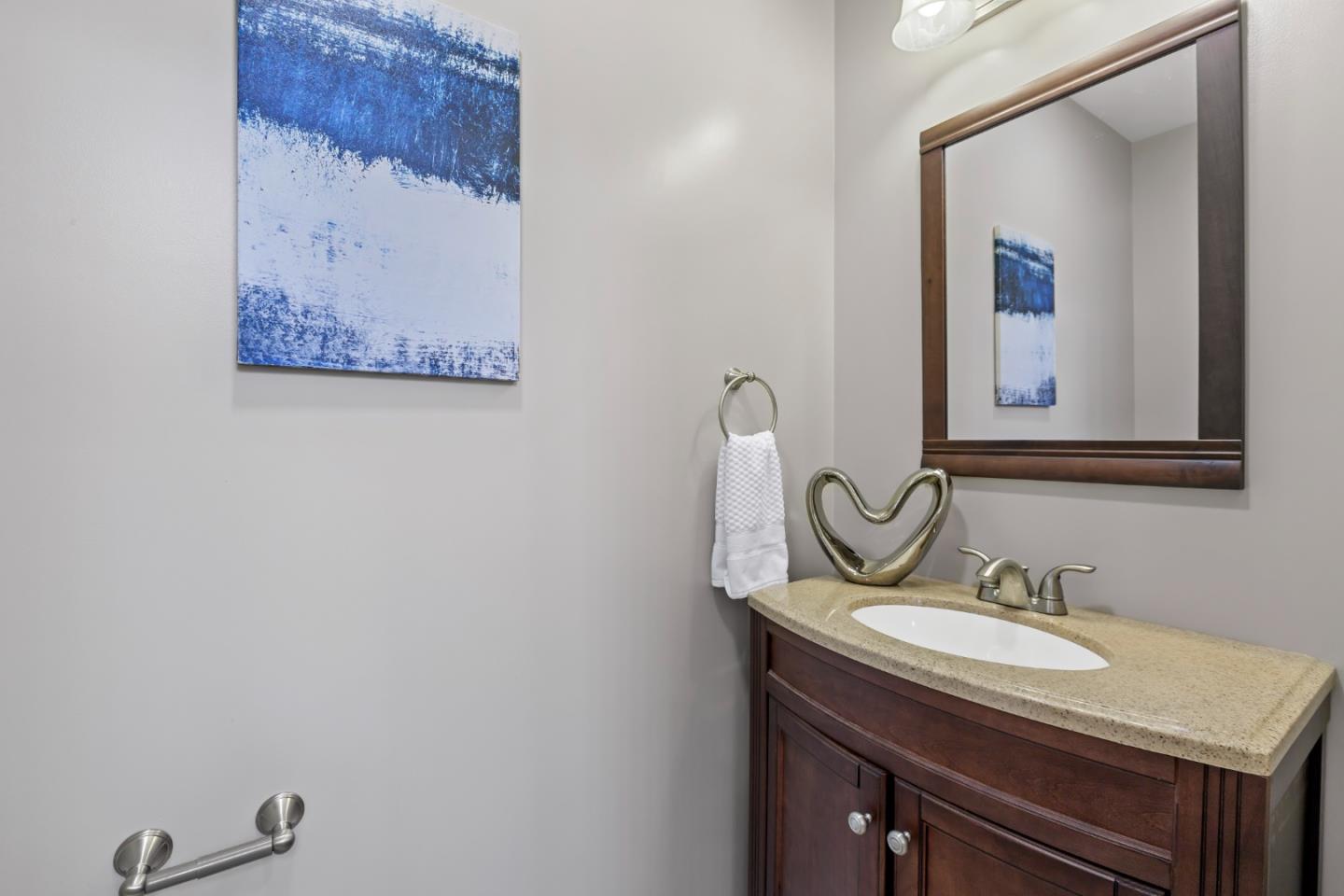 1001 Harvard Road San Mateo, CA 94402 - Photo 38 of 54 a bathroom with a sink and a mirror