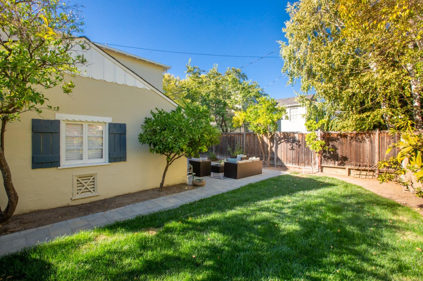 1001 Harvard Road San Mateo, CA 94402 - Photo 40 of 54 a view of a backyard with table and chairs and potted plants