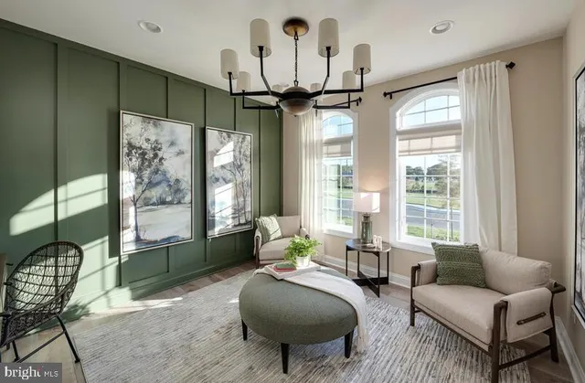 a living room with furniture a chandelier and a large window