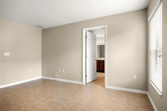 an empty room with windows and closet