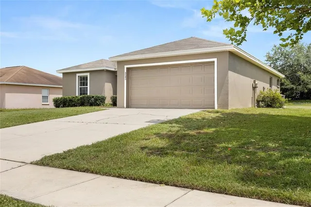 a front view of house with yard and green space