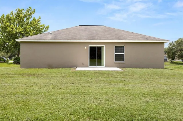 a front view of house with yard and trees