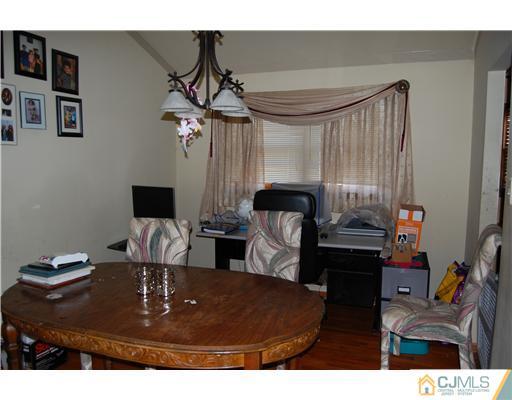 23 Barton Road Old Bridge, NJ 08857 - Photo 5 of 7 a living room with furniture and a fireplace